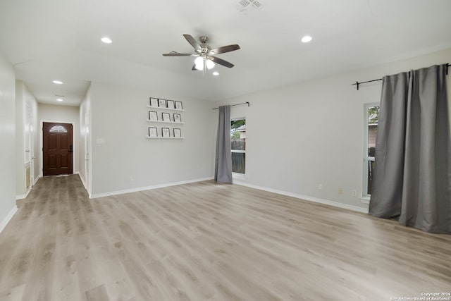 empty room featuring ceiling fan and light hardwood / wood-style flooring