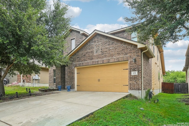 view of front of property with a front lawn and a garage