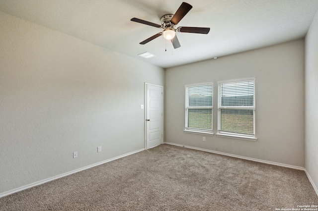 unfurnished room featuring ceiling fan and carpet floors