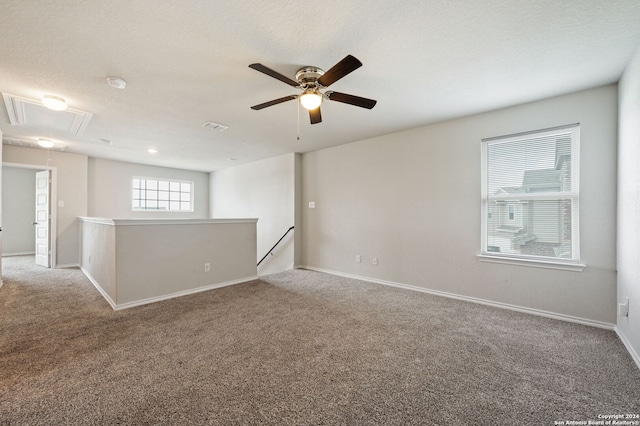 carpeted empty room featuring a textured ceiling and ceiling fan