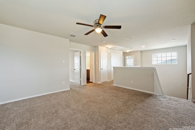 carpeted spare room with ceiling fan