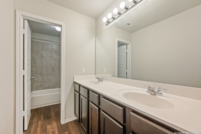 bathroom with vanity, tiled shower / bath combo, and hardwood / wood-style floors