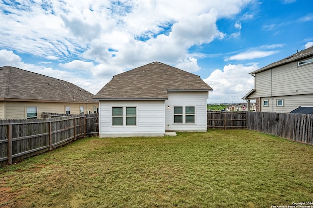 rear view of house with a lawn