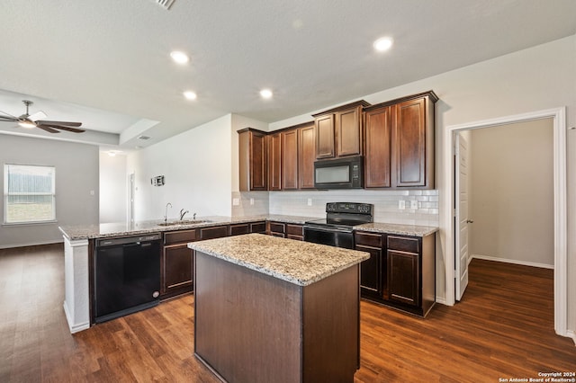 kitchen featuring black appliances, dark hardwood / wood-style flooring, kitchen peninsula, sink, and ceiling fan