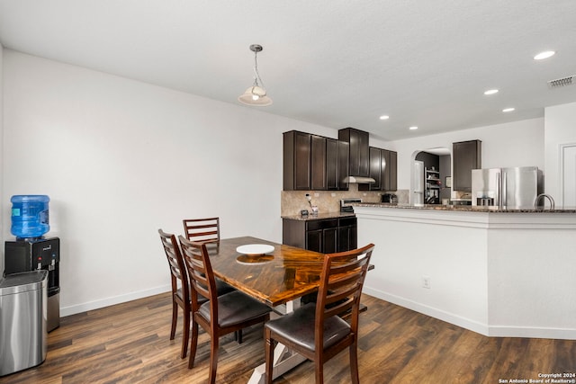 dining area featuring a textured ceiling and dark hardwood / wood-style flooring