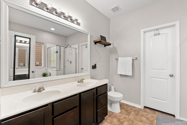 bathroom featuring walk in shower, toilet, and vanity