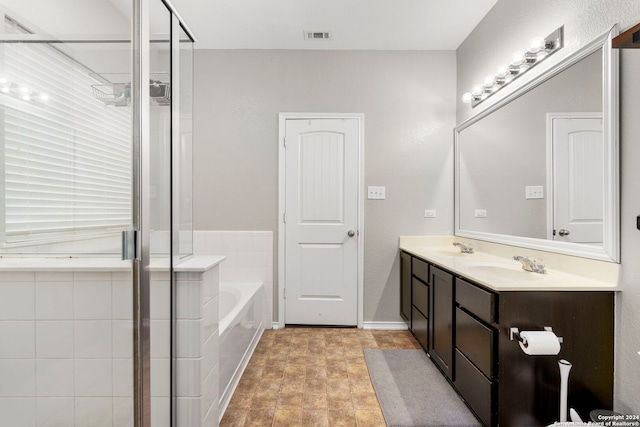 bathroom featuring vanity and shower with separate bathtub