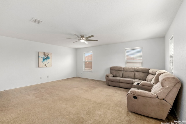 living room featuring ceiling fan and light carpet