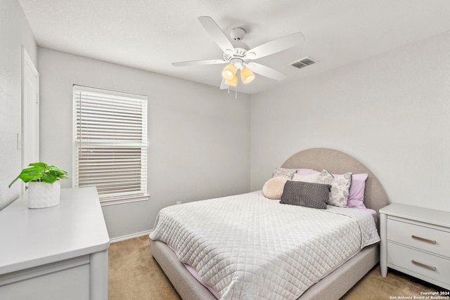 bedroom with light colored carpet and ceiling fan