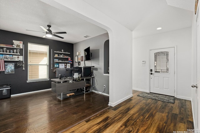 foyer entrance featuring dark wood-type flooring, a textured ceiling, and ceiling fan