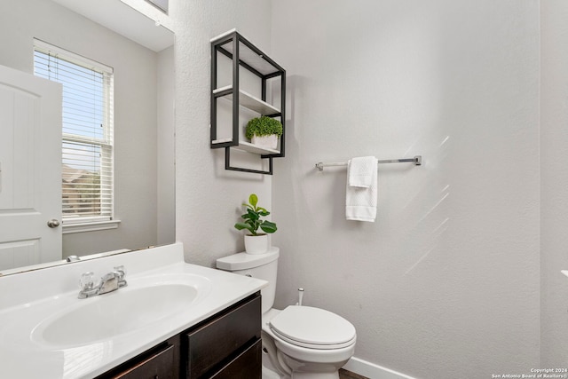 bathroom featuring toilet and vanity