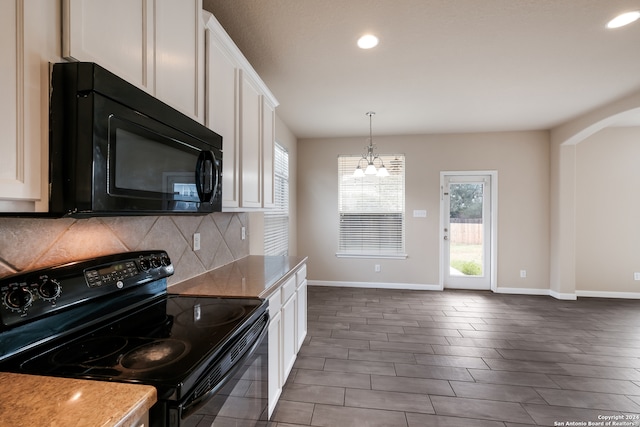 kitchen with a chandelier, black appliances, decorative backsplash, dark hardwood / wood-style floors, and white cabinets