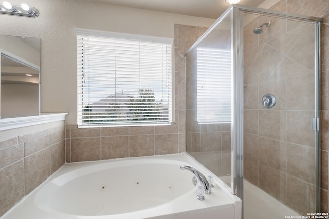 bathroom with separate shower and tub