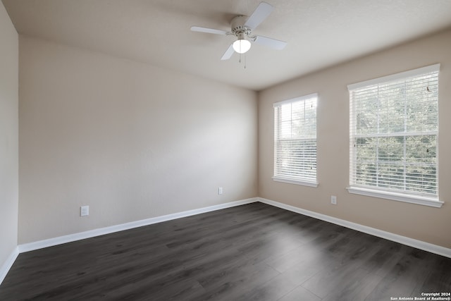 unfurnished room with ceiling fan and dark hardwood / wood-style flooring