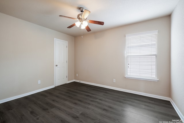 empty room featuring ceiling fan and dark hardwood / wood-style floors