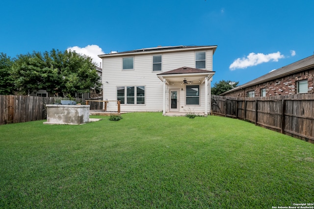 back of house featuring ceiling fan, a yard, and a patio