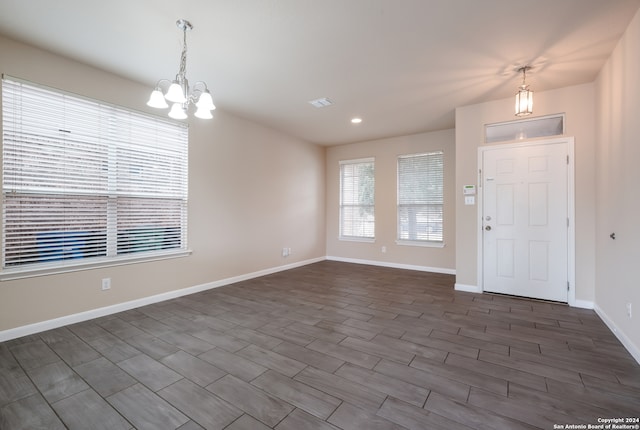 entryway featuring a chandelier and dark hardwood / wood-style flooring