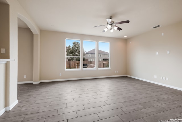 empty room with light hardwood / wood-style flooring and ceiling fan