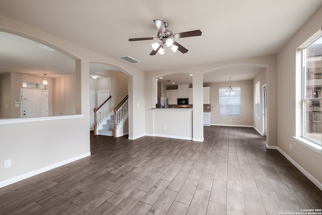 unfurnished living room with ceiling fan and wood-type flooring