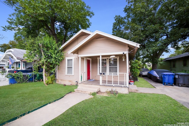 bungalow featuring a front lawn and a porch