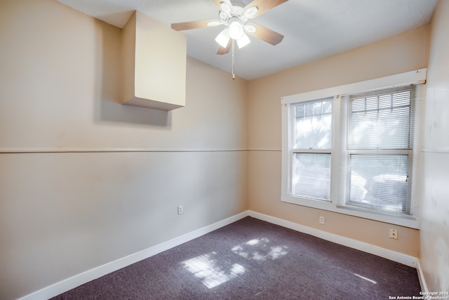 unfurnished room featuring a wealth of natural light, carpet flooring, and ceiling fan