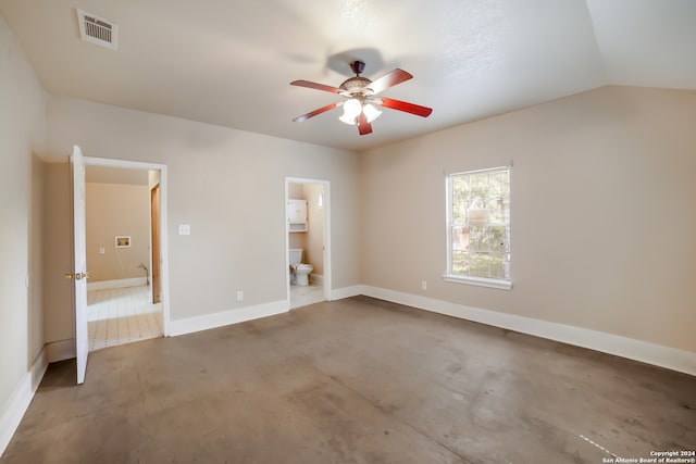 unfurnished bedroom featuring vaulted ceiling, ceiling fan, ensuite bathroom, and concrete flooring