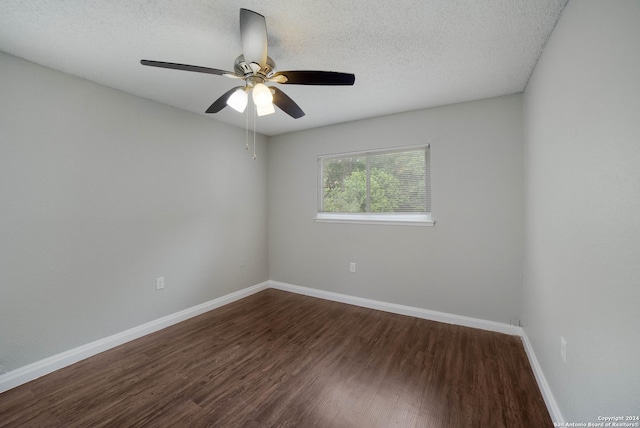 empty room with a ceiling fan, a textured ceiling, baseboards, and wood finished floors