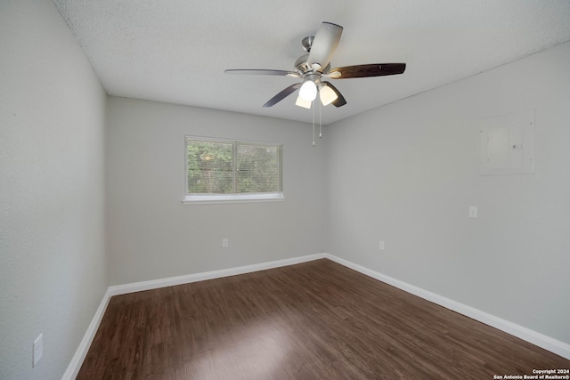 unfurnished room with dark wood-style floors, ceiling fan, and baseboards