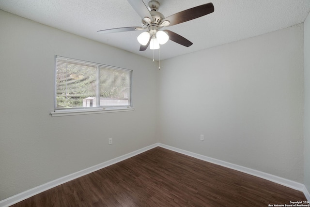 unfurnished room featuring a textured ceiling, ceiling fan, dark wood-type flooring, and baseboards