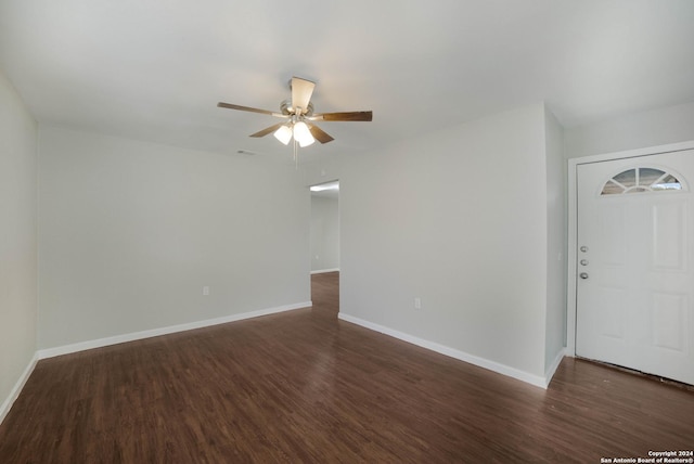 interior space with a ceiling fan, visible vents, baseboards, and wood finished floors