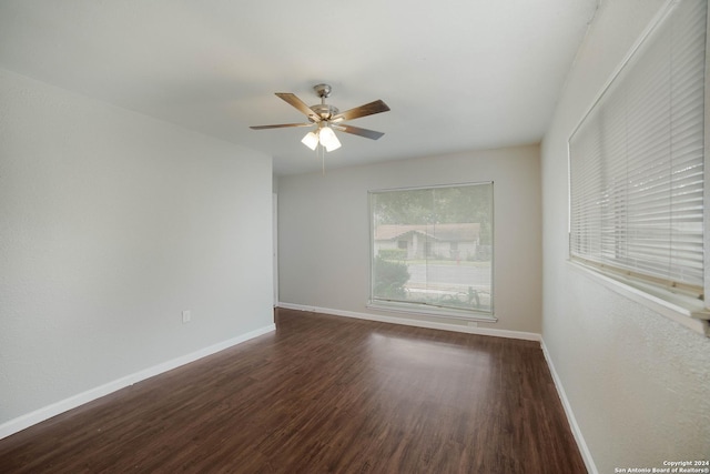 empty room featuring a ceiling fan, baseboards, and wood finished floors