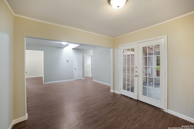 spare room with french doors, crown molding, and wood finished floors