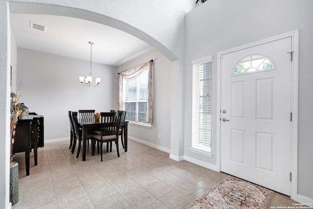 entrance foyer featuring light tile patterned floors and a chandelier