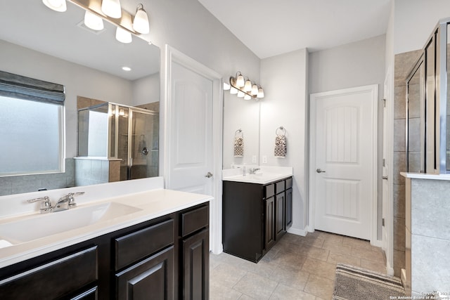 bathroom featuring vanity, a shower with shower door, and tile patterned floors