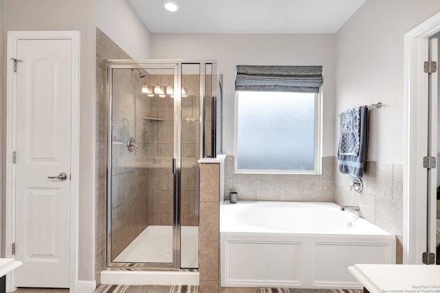 bathroom with separate shower and tub