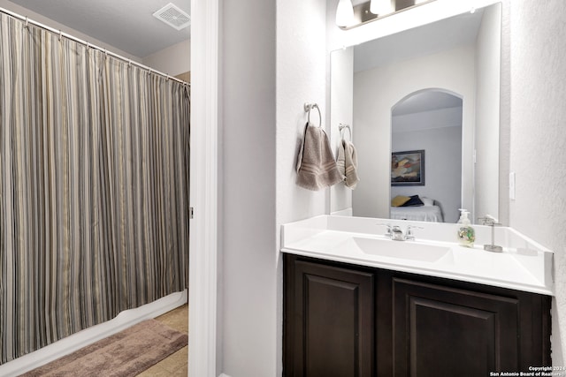 bathroom with vanity and a shower with curtain