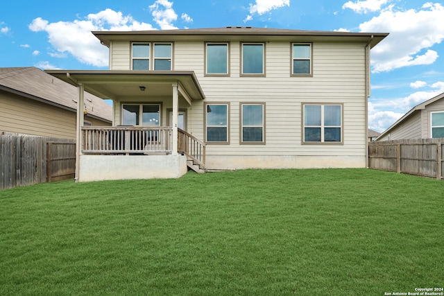 rear view of house with a lawn