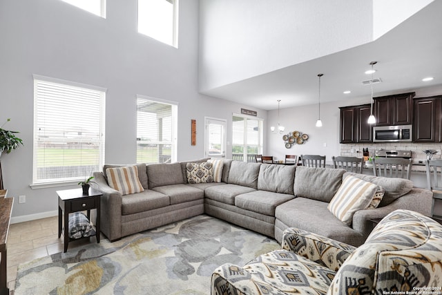 tiled living room featuring a high ceiling