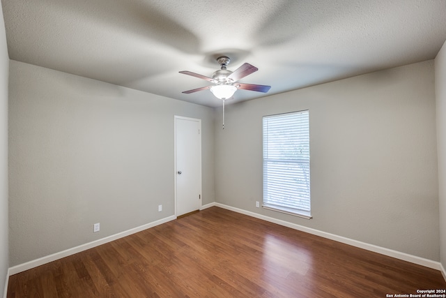 spare room with wood-type flooring, a textured ceiling, and ceiling fan