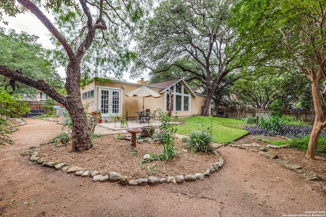 exterior space with a front yard and a patio area