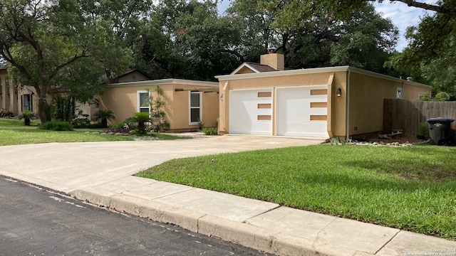 view of front of property with a front yard and a garage