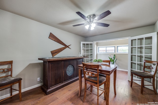 dining area featuring a textured ceiling, ceiling fan, and hardwood / wood-style flooring