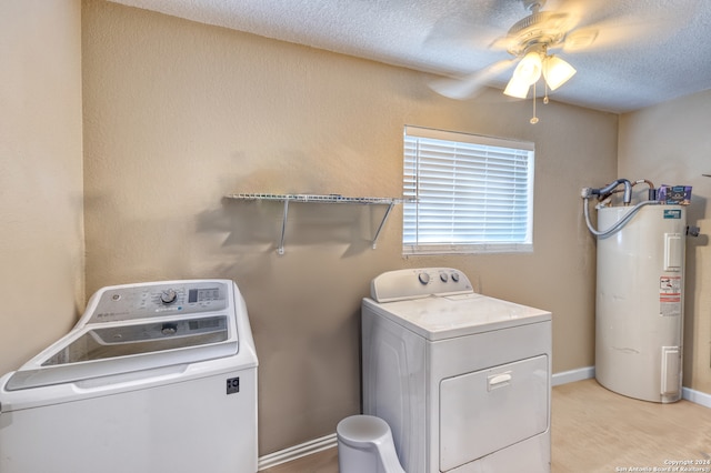 washroom featuring washer and dryer, a textured ceiling, electric water heater, and ceiling fan