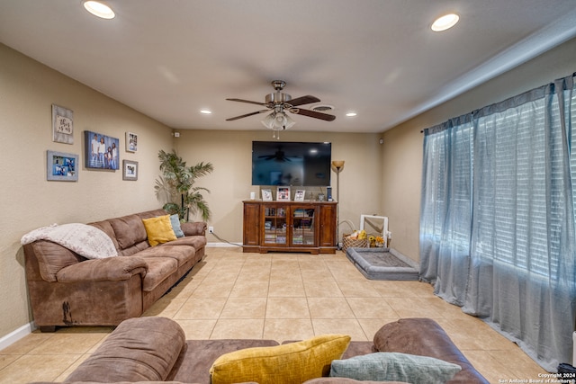 tiled living room with ceiling fan