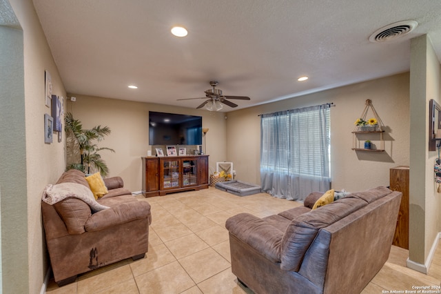 tiled living room featuring ceiling fan