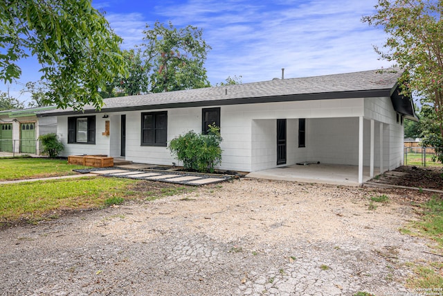 single story home featuring a carport