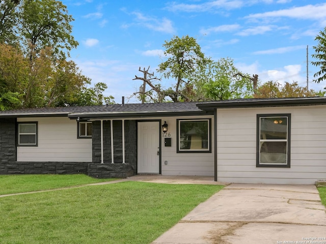 ranch-style home with a porch and a front yard