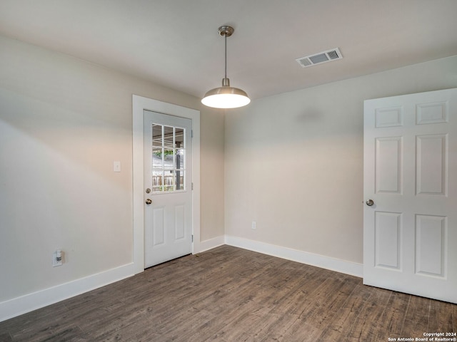 empty room with dark wood-type flooring