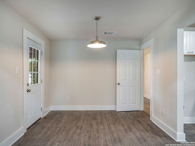 unfurnished dining area featuring dark hardwood / wood-style floors