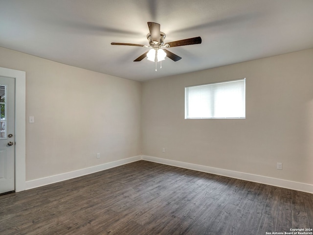 spare room featuring ceiling fan and dark hardwood / wood-style floors